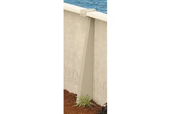 Concrete in-ground pool wall installation with decorative finish and landscaping