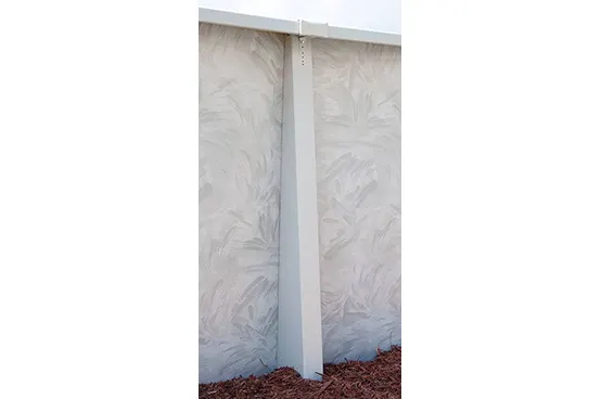 White above-ground pool wall panel with support post and mulch base