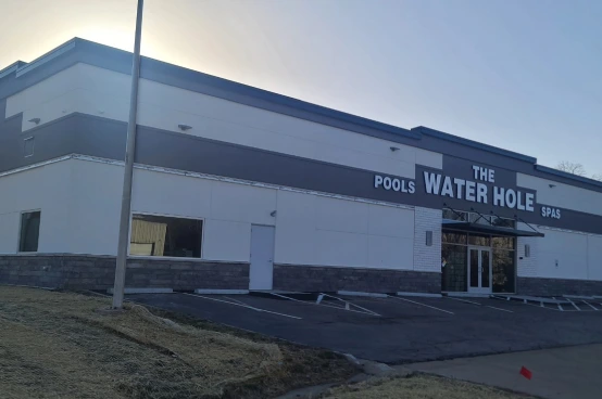 The Water Hole storefront featuring pools, hot tubs, and swimming pool supplies